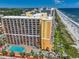 An aerial view captures this impressive beachfront high-rise, highlighting its proximity to the beach at 6900 N Ocean Blvd. # 405, Myrtle Beach, SC 29572