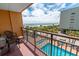 Balcony view of the beach and pool area with comfortable seating, and a serene view of the ocean at 6900 N Ocean Blvd. # 405, Myrtle Beach, SC 29572