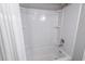 Clean bathroom features an enclosed shower/tub combo with built-in shelves and white tile at 6900 N Ocean Blvd. # 405, Myrtle Beach, SC 29572