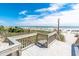 A wood walkway provides access to the beach and ocean area with clear blue skies on a sunny day at 6900 N Ocean Blvd. # 405, Myrtle Beach, SC 29572