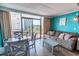 Bright living area with dining table, comfortable seating, and balcony access with city views at 6900 N Ocean Blvd. # 405, Myrtle Beach, SC 29572