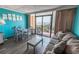 Cozy living space with a dining area and balcony overlooking ocean, furnished with a comfortable sofa at 6900 N Ocean Blvd. # 405, Myrtle Beach, SC 29572