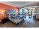 Comfortable main bedroom featuring a plush queen bed, dining area and a balcony at 6900 N Ocean Blvd. # 405, Myrtle Beach, SC 29572