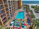 Aerial view of a resort with a pool, splash pad, manicured landscaping, ocean views, and direct beach access at 6900 N Ocean Blvd. # 405, Myrtle Beach, SC 29572