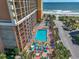 Aerial view of a resort with a pool, splash pad, manicured landscaping and ocean views at 6900 N Ocean Blvd. # 405, Myrtle Beach, SC 29572