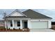 Charming single-Gathering home with white siding, covered porch, and two-car garage, ready for move-in at 819 Buttonwood Dr., Conway, SC 29527