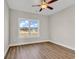 Bright bedroom with ceiling fan and large window with backyard view at 107 Deans Ct., Green Sea, SC 29545