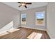Bright bedroom with ceiling fan and two large windows with view at 107 Deans Ct., Green Sea, SC 29545