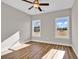 Bright bedroom with ceiling fan and two large windows with view at 107 Deans Ct., Green Sea, SC 29545