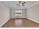 Bright primary bedroom with luxury vinyl plank flooring, ceiling fan, and view at 107 Deans Ct., Green Sea, SC 29545