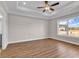 Primary bedroom features luxury vinyl plank flooring, ceiling fan, and a large window at 107 Deans Ct., Green Sea, SC 29545