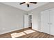 This bedroom features hardwood floors, neutral walls, a ceiling fan and a double door closet at 107 Deans Ct., Green Sea, SC 29545