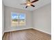Bright bedroom with ceiling fan and large window with backyard view at 107 Deans Ct., Green Sea, SC 29545
