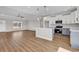 Open-concept kitchen boasts a large island, modern appliances, and elegant white and gray cabinetry in a brightly lit space at 107 Deans Ct., Green Sea, SC 29545