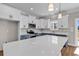Bright kitchen boasts stainless appliances, two-tone cabinets, and a large white quartz island at 107 Deans Ct., Green Sea, SC 29545