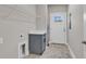 Functional laundry room with gray cabinets, quartz countertop, and tile flooring at 107 Deans Ct., Green Sea, SC 29545