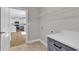 Functional laundry room with grey cabinets, quartz countertop, and access to the kitchen at 107 Deans Ct., Green Sea, SC 29545