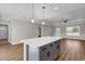 Open floorplan features a large quartz kitchen island, recessed lights, and tray ceiling at 107 Deans Ct., Green Sea, SC 29545