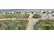 Scenic view of a sandy beach with beachgoers, umbrellas, and vegetation at 2504 N Ocean Blvd. # 734, Myrtle Beach, SC 29577