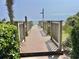 Wooden walkway leading to a sunny beach with lush greenery on either side at 2504 N Ocean Blvd. # 734, Myrtle Beach, SC 29577