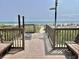 Wooden boardwalk with showers and seating area leading to a beach with umbrellas at 2504 N Ocean Blvd. # 734, Myrtle Beach, SC 29577