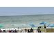 Ocean view of beachgoers relaxing under colorful umbrellas by the calming sea waves at 2504 N Ocean Blvd. # 734, Myrtle Beach, SC 29577