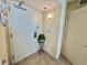 A condo entryway with a white door, tiled floors, and a decorative plant at 2504 N Ocean Blvd. # 734, Myrtle Beach, SC 29577