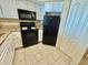 A full view of the kitchen, featuring white cabinets and black appliances at 2504 N Ocean Blvd. # 734, Myrtle Beach, SC 29577