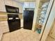 A cozy kitchen with white cabinets, black appliances, and ample storage space at 2504 N Ocean Blvd. # 734, Myrtle Beach, SC 29577