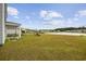 Expansive backyard with playset, pond and covered patio at 128 Caveson Way, Conway, SC 29526