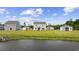 A picturesque view of the backyard, showcasing the peaceful pond and the green spaces surrounding the homes at 128 Caveson Way, Conway, SC 29526