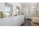 Bright bathroom features dual sinks, modern fixtures, and a glass-enclosed shower at 128 Caveson Way, Conway, SC 29526
