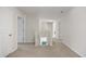 Upstairs hallway with neutral walls, carpet and white doors at 128 Caveson Way, Conway, SC 29526