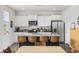Bright eat-in kitchen with stainless appliances, large island and counter seating, and wooden dining table at 128 Caveson Way, Conway, SC 29526