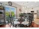 Glass-top dining table with four ornate chairs near kitchen at 417 Pennington Loop, Myrtle Beach, SC 29588