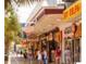 Street view of beachfront shopping with people strolling by and store front signage at 728 Isle Verde Dr, Myrtle Beach, SC 29579