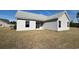 The backyard features light siding with a sliding glass door and two windows at 1248 Wehler Ct., Conway, SC 29526