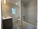 Bright bathroom boasts tile flooring, a shower-tub combination, and a modern single sink vanity at 1248 Wehler Ct., Conway, SC 29526
