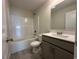 Cozy bathroom with a shower and tub combo, toilet and a vanity with a sink and a gray cabinet at 1248 Wehler Ct., Conway, SC 29526