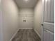 A laundry room with gray tile flooring and wire shelving with appliance hookups ready for installation at 1248 Wehler Ct., Conway, SC 29526