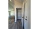 An open pantry with wire shelving adjoins a spacious living area with gray flooring and a ceiling fan at 1248 Wehler Ct., Conway, SC 29526