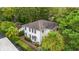 Aerial view of a two-story white home surrounded by lush trees and landscaping at 412 29Th Ave. N, Myrtle Beach, SC 29577