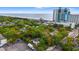 Aerial view of property near the beach, featuring lush trees and an outdoor parking area at 412 29Th Ave. N, Myrtle Beach, SC 29577