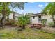 View of backyard with a red picnic table, palm tree, and partial views of the house at 412 29Th Ave. N, Myrtle Beach, SC 29577
