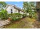 View of the side of the house and backyard with lush greenery and a brick walkway at 412 29Th Ave. N, Myrtle Beach, SC 29577