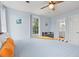 Bedroom with light blue walls, ceiling fan, window, and bed with gray linens and orange pillows at 412 29Th Ave. N, Myrtle Beach, SC 29577