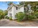 This white home is nestled among lush landscaping, offering privacy and tranquility at 412 29Th Ave. N, Myrtle Beach, SC 29577