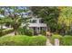Charming two-story home with white siding, screened porch, and lush landscaping, creating curb appeal at 412 29Th Ave. N, Myrtle Beach, SC 29577