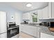 Charming kitchen with white cabinets, granite countertops, stainless steel appliances, and natural light at 412 29Th Ave. N, Myrtle Beach, SC 29577