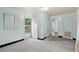 Small empty room with an exterior door, grey carpet, and light blue walls at 412 29Th Ave. N, Myrtle Beach, SC 29577